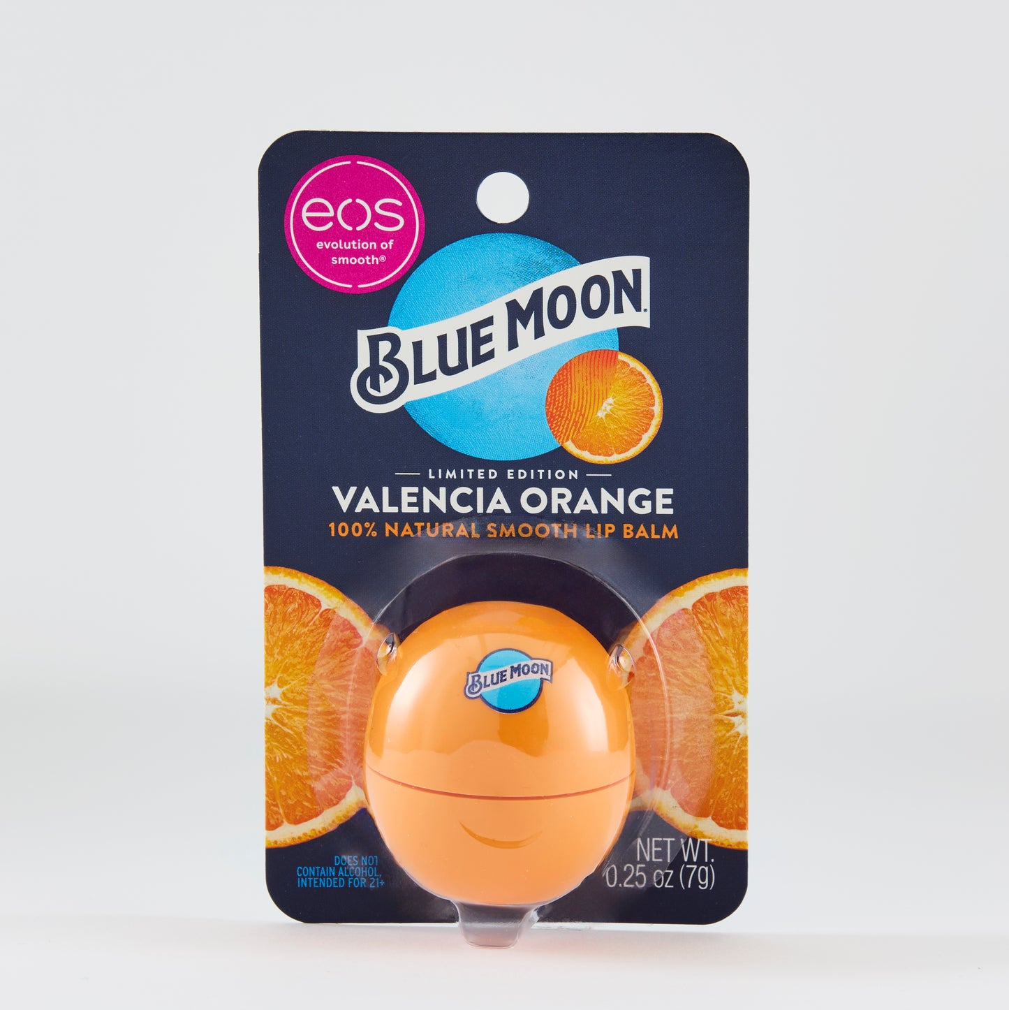 Orange eos-style lip balm package with a Blue Moon–branded orange container inside. The card reads: “BLUE MOON,” “VALENCIA ORANGE,” and “100% NATURAL SMOOTH LIP BALM,” with sliced orange images behind the product.